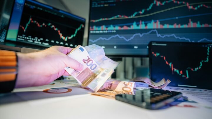 Euro and financial market screens illustrating European stocks and bond-market pressure
